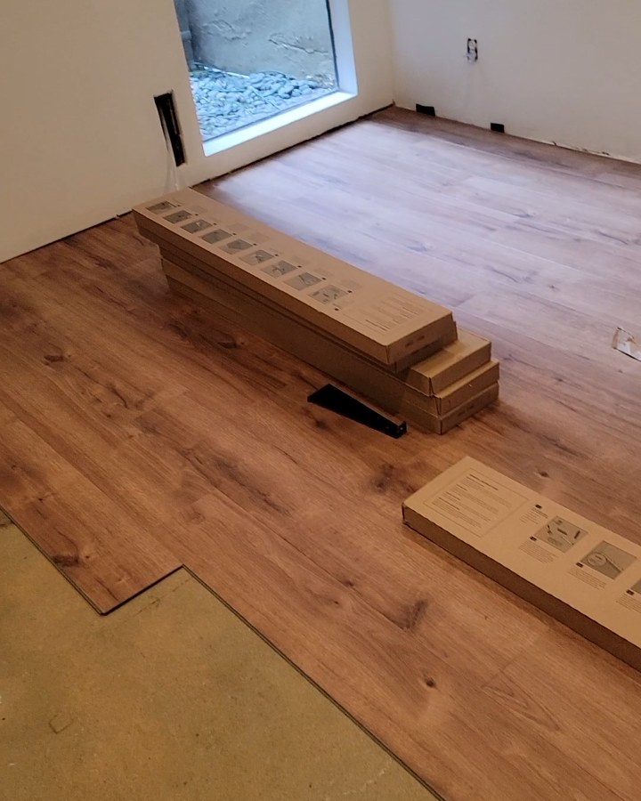 Laying the new floor by hand during the Gateway Acupuncture build-out